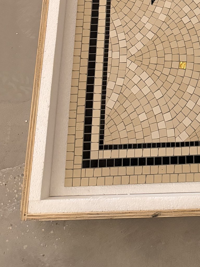 Custom scalloped mosaic tile inlay during installation